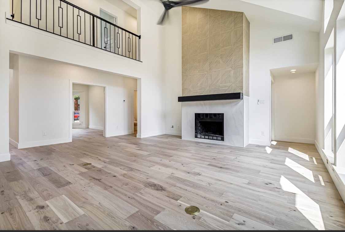 Two-Story Fireplace Feature Wall in Prosper, TX by SHADELE Design & Remodeling