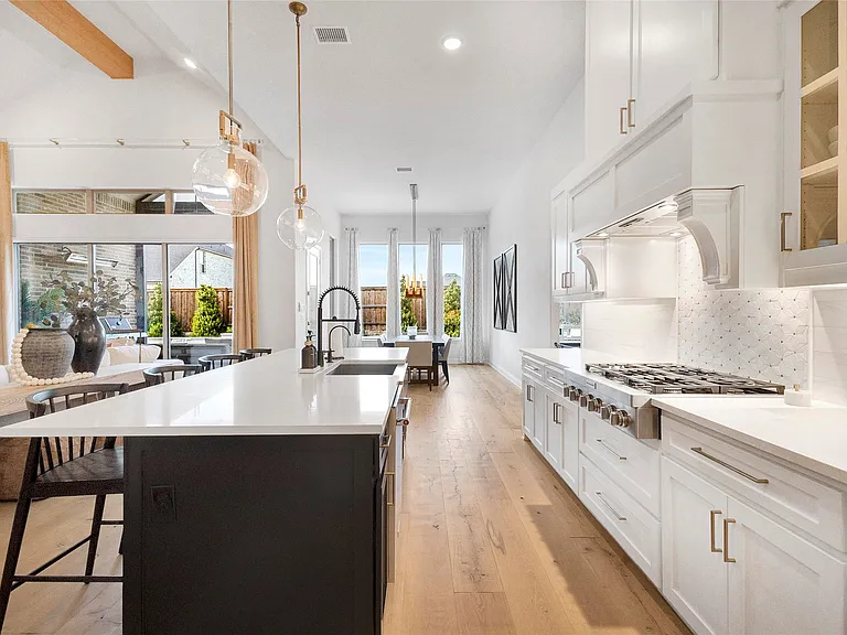Galley Kitchen with Custom Hood in Prosper, TX by SHADELE Design & Remodeling